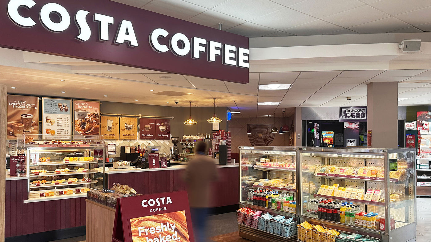 Costa Coffee shop interior with various products on display.
