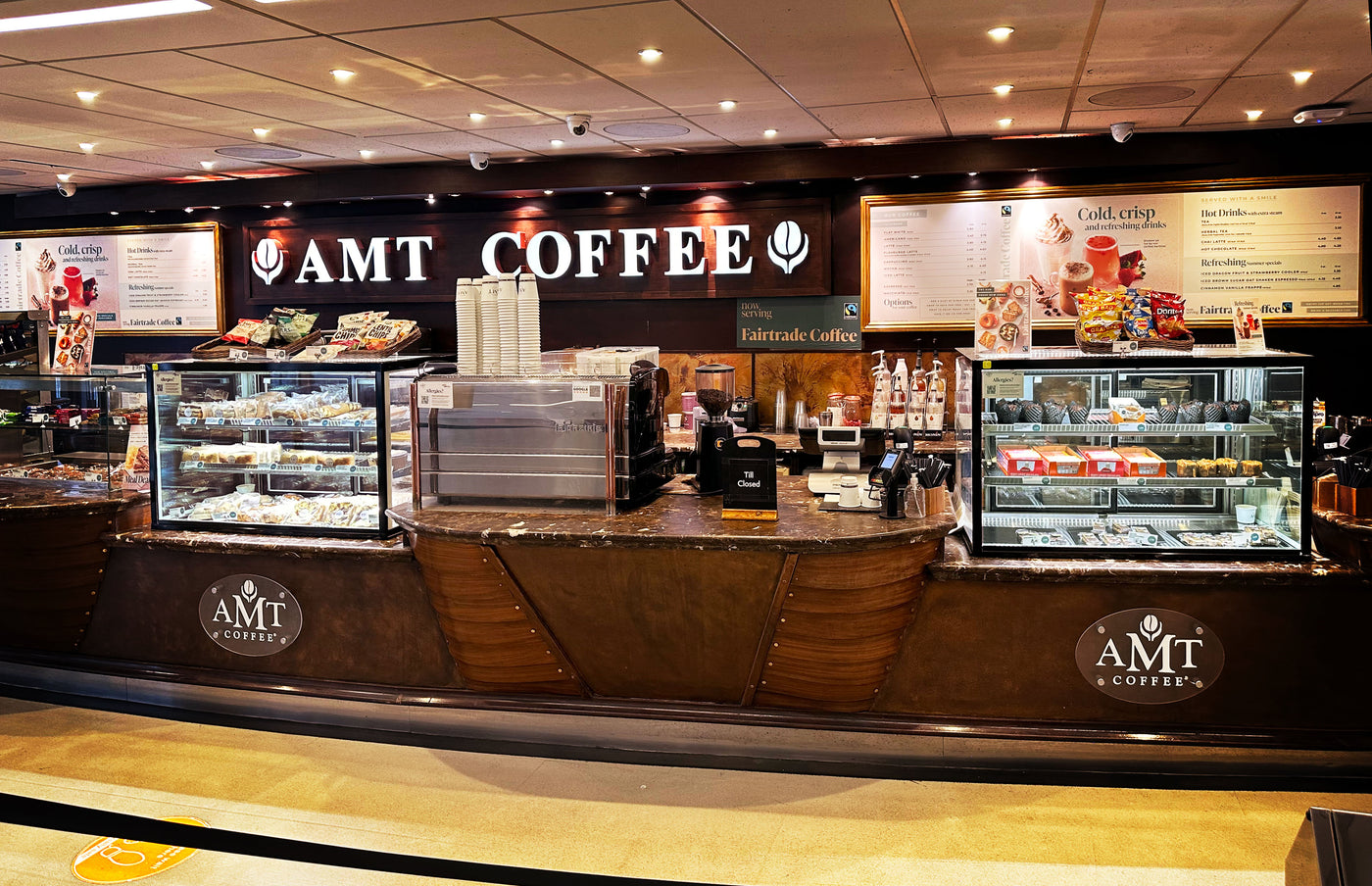 AMT Coffee store interior with counter and display cases.