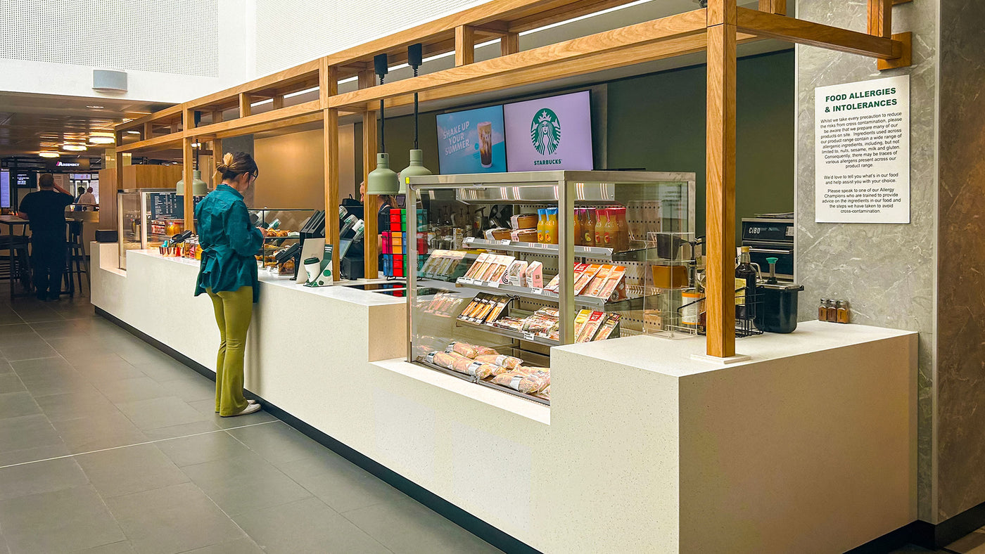 Starbucks store interior with a customer at the counter.